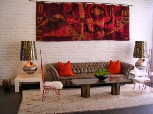 Brown leather Chesterfield sofa in a designer living room with red pops