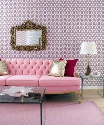 Pale pink tufted tuxedo sofa in a designer feminine living room. Fantastic use of gold with the purple and pink wallpaper