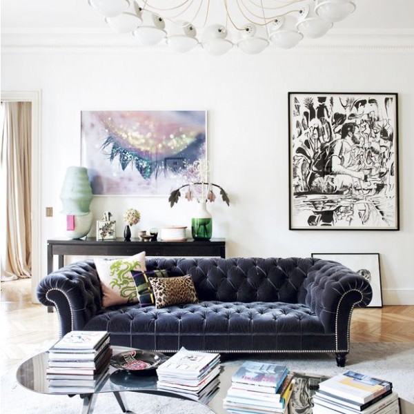 Gray (almost blue) velvet Chesterfield sofa in a designer living room